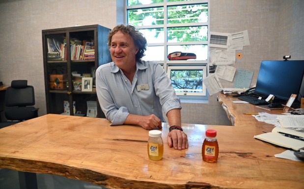 Mike Abt, formerly of Glencoe, also Abt co-president, in Abt's office with samples of Abt's locally produced honey on Oct. 29, 2024. (Karie Angell Luc/Pioneer Press)