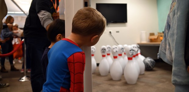 Spider-Man Parker Parfitt, 4, of Gurnee looks at the bowling challenge ahead for the tot to try at the Mini Comic Con at the Vernon Area Public Library on Nov. 16, 2024 in Lincolnshire (Karie Angell Luc/Pioneer Press)