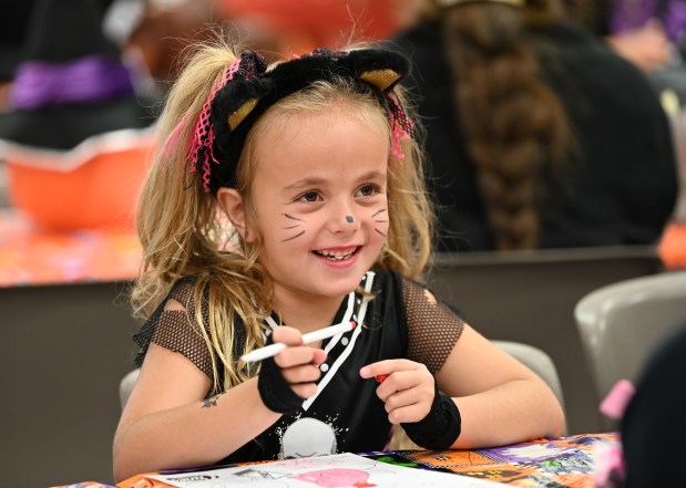 Greis Ocelli, a first-grader from Harwood Heights, makes party craft coloring art at the Harwood Heights Youth Commission Halloween Party on Oct. 26, 2024 at the Harwood Heights Recreation Center in Harwood Heights. (Karie Angell Luc/Pioneer Press)