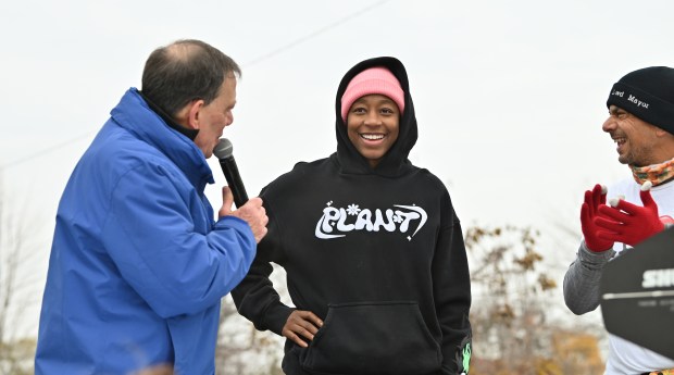 Center, Jewell Loyd, a professional basketball player and two time U.S. Gold Olympian from Lincolnwood and of the Niles West High School Class of 2012, is a surprise celebrity being welcomed at stage at the start line of the Lincolnwood Turkey Trot on Nov. 24, 2024 in Lincolnwood. (Karie Angell Luc/Pioneer Press)