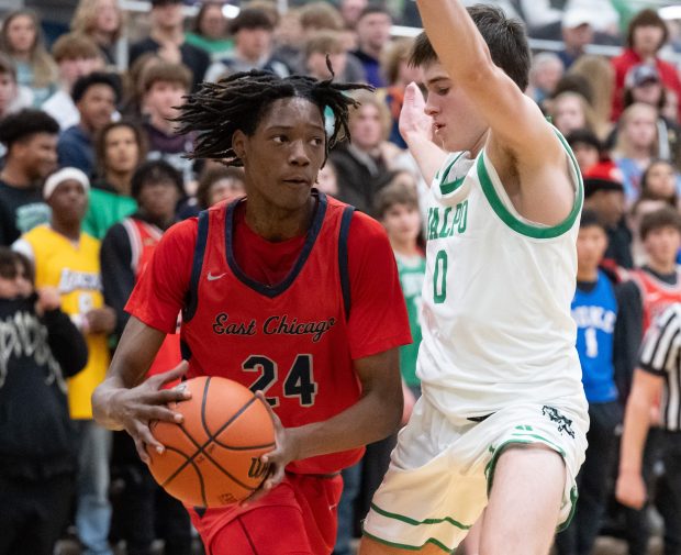 East Chicago Central's Yamauree Wallace drives to the basket against Valparaiso's Jack Smiley during a game in Valparaiso on Friday, Dec. 1, 2023. (Kyle Telechan for the Post-Tribune)