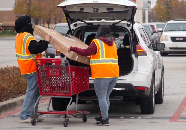 Target employees load a television into a vehicle on Black Friday in Highland on Friday, Nov. 29, 2024. (Michael Gard/for the Post-Tribune)