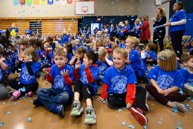 Children react as Porter Lakes Elementary faculty shoot confetti cannons into the air during a celebration to recognize the school attaining Blue Ribbon recognition earlier this year on Monday, Nov. 11, 2024. (Kyle Telechan/for the Post-Tribune)