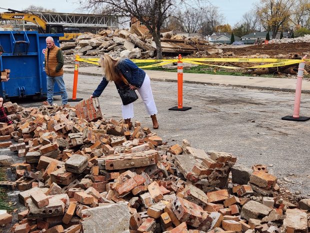 Julie Marvel Sopata, Chesterton High School class of 1988, picks through a selection of bricks at the former Chesterton Middle School on Friday, Nov. 15, 2024. (Shelley Jones/for Post-Tribune)