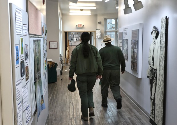 Park rangers walk through the new Indiana Dunes National Park's Paul H. Douglas Center for Environmental Education after a ribbon cutting ceremony for the new pedestrian bridge on Monday, Nov. 4, 2024. (John Smierciak / Post Tribune)