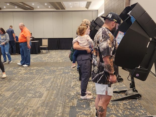 Kouts voter Nicholas Havens, far right, votes on Tuesday, Nov. 5, 2024, at the Porter County Expo Center. (Shelley Jones/for Post-Tribune)