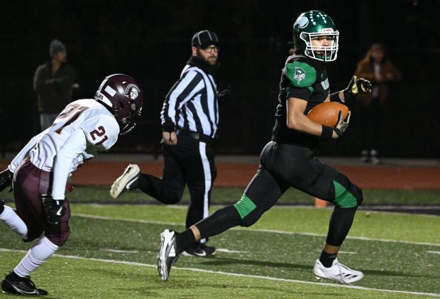 Valparaiso wide receiver Julian Stokes outruns Chesterton defensive back Jude Palm for touchdown during the Class 5A sectional championship game on Friday, Nov. 8, 2024. (Kyle Telechan/for the Post-Tribune)