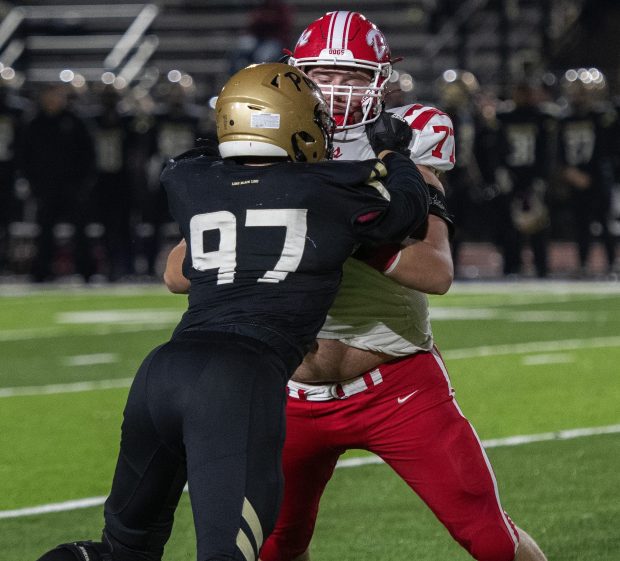 Crown Point's Nolan Cicero grabs Penn's Quinn Watson during the Class 6A sectional championship game in Mishawaka on Friday, Nov. 8, 2024. (Michael Gard/for the Post-Tribune)