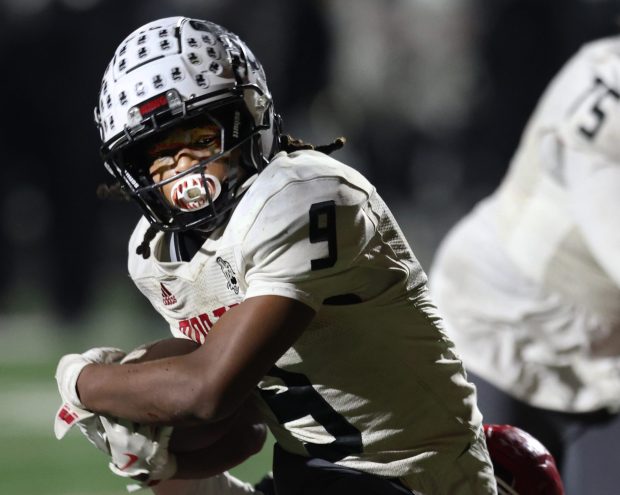 Morton running back Martel Kelly breaks a Munster tackle and goes into score during the Class 5A sectional semifinal football game in Munster on Friday, Nov. 1, 2024. (John Smierciak / Post Tribune)