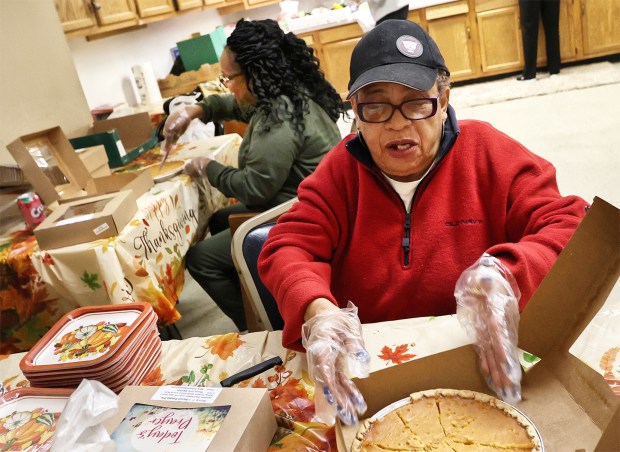 Pat Ware (left) and Alicia Hill cut up sweet potato pies as volunteers set up fort the Harvest Feast which is held in honor of State Rep. Vernon G. Smith's mother, the late Rev. Julia E. Smith, and his aunt Magnolia Allen. The event included a short religious service followed by a traditional Thanksgiving dinner. The event was free and open to the public on Friday, Nov. 22, 2024. (John Smierciak / Post-Tribune)