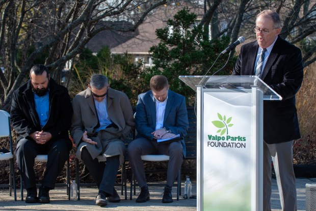 Porter County Sheriff's chaplain Jay Birky, right, gives the benediction as veteran Steven Bramer, mayor Jon Costas and director of Parks and Recreation Kevin Nuppnau (left to right) join in during the Veterans Day Ceremony held in at the Service Memorial At Foundation Meadows in Valparaiso, Indiana Friday Nov. 8, 2024.(Andy Lavalley/for the Post-Tribune)