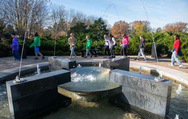 Central Elementary fifth graders walk around the fountain following the Veterans Day Ceremony held at the Service Memorial at Foundation Meadows in Valparaiso, Indiana Friday Nov. 8, 2024.(Andy Lavalley/for the Post-Tribune)