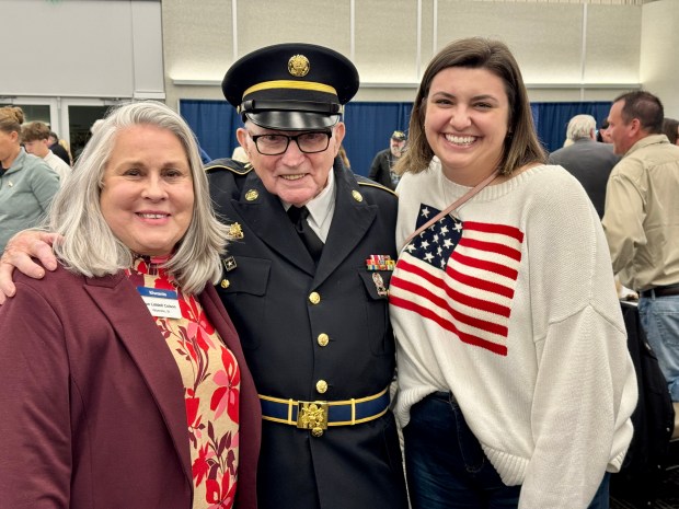 Charles Martin, of LaPorte, is flanked by Valparaiso Kiwanis member Sue Liddell Colson, left, and Lindsey DeBoer, of Valparaiso, at the annual Valparaiso Kiwanis and Rotary clubs' veterans recognition dinner on Sunday, Nov. 17, 2024, at the Porter County Expo Center. (Doug Ross/for Post-Tribune)