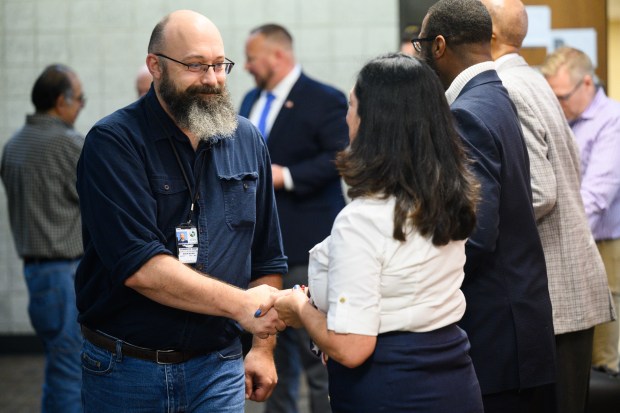 U.S. Army veteran and Lake County Economic Development inspector Jason Ryder, on left, shakes hands with county council president Christine Cid during an event to honor Lake County veterans in Crown Point on Thursday, Nov. 7, 2024. (Kyle Telechan/for the Post-Tribune)