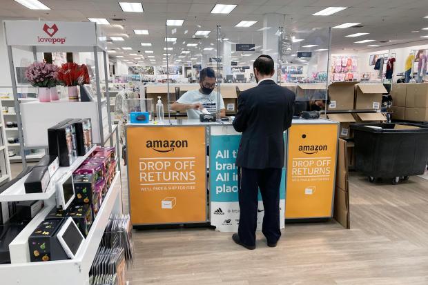 People return items purchased online at an Amazon counter inside a Kohl's department store in Clifton, New Jersey, on Sept. 3, 2021. (AP Photo/Ted Shaffrey)