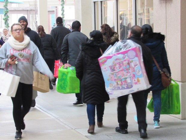 Shoppers look for bargains at Chicago Premium Outlets mall in Aurora during a previous holiday season. The Aurora police have said they will close some roads near the mall on Friday to improve traffic flow due to the large number of shoppers expected on Black Friday. (David Sharos / For The Beacon-News)