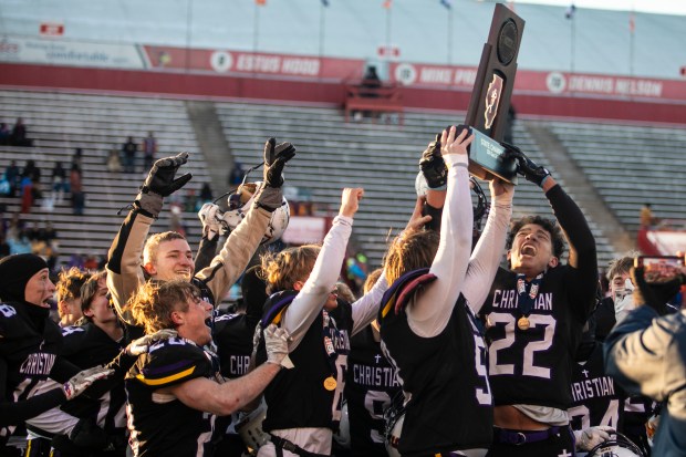 Chicago Christian's Niko Griggs (22) and Brock Sperling hold up the championship trophy after defeating Maroa-Forsyth in the Class 2A state championship game at Hancock Stadium in Normal on Friday, Nov. 29, 2024. (Vincent D. Johnson / for the Daily Southtown)