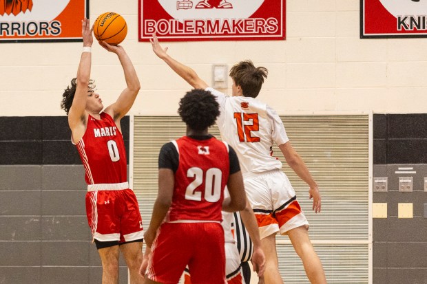 Marist's Anthony Vassilakis (0) puts up a shot overShepard's Zachary Cosme (12) during the Andrew/Lincoln-Way Central Tournament in Tinley Park on Tuesday, Nov. 26, 2024. (Vincent D. Johnson / for the Daily Southtown)