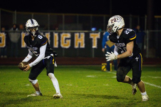 Chicago Christian's Christian Flutman (6) hands off the ball to teammate Kenny Jager (20) during a Class 2A state quarterfinal game against Bismark-Henning on Saturday, Nov. 16, 2024, at Chicago Christian High School in Palos Heights, Ill. (Vincent Alban / Daily Southtown)