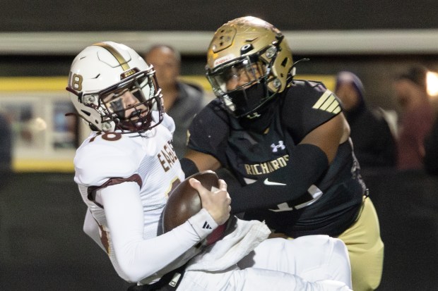 Richards's Johnny Lipscomb (35) tackles Dunlap's John Bergen (18) during a Class 6A first-round game in Oak Lawn on Friday, Nov. 1, 2024. (Troy Stolt / for the Daily Southtown)