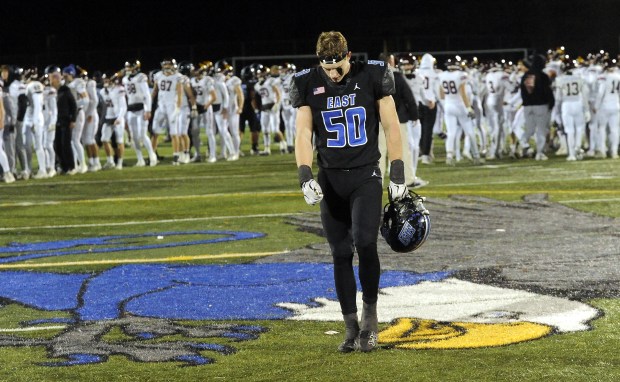 Lincoln-Way East's Caden O'Rourke (50) walks off the field to his teammates after the Griffins 24-27 loss to Loyola during the Class 8A state semifinals Saturday, Nov. 23, 2024 in Frankfort, IL. (Steve Johnston/for the Daily Southtown)