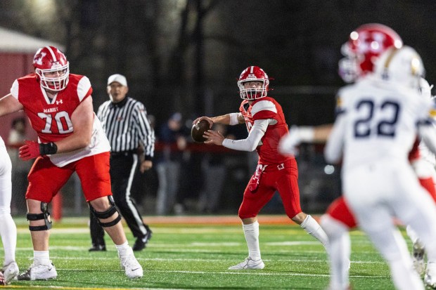 Marist's Jacob Ritter (12) drops back to pass against Glenbrook South during the Class 8A first-round game in Chicago on Friday, Nov. 1, 2024. (Vincent D. Johnson / for the Daily Southtown)