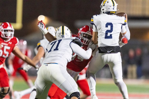 Marist's Brad Fitzgibbon pushes past Glenbrook South's Alex Limperis (71) to help on a strip sack on quarterback Glenbrook South's Andrew Bonvechio (2) during the Class 8A first-round game in Chicago on Friday, Nov. 1, 2024. (Vincent D. Johnson / for the Daily Southtown)