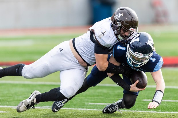 Joliet Catholic's James Lee (99) sacks Nazareth Academy's Logan Malachuk (1) in the Class 5A state championship game at Hancock Stadium in Normal on Saturday, Nov. 30, 2024. (Vincent D. Johnson / for the Daily Southtown)