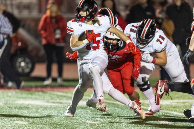 Lincoln-Way Central's Tyler Tulk (15) spins around to shake a Bradley-Bourbonnais defender in the Class 7A state quarterfinals in Bradley on Friday, Nov. 15, 2024. (Vincent D. Johnson / for the Daily Southtown)