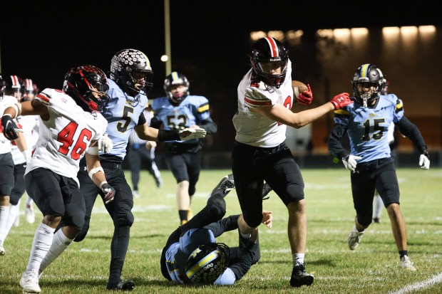 Lincoln Way Central wide receiver Luke Tingley (2) breaks loose of a tackle by Maine West tight end Landon Sebo (17) during a Class 7A first-round game at Maine West High School in Des Plaines on Friday, Nov. 1, 2024. (Talia Sprague / Daily Southtown)