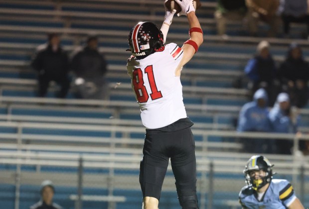 Lincoln Way Central wide receiver Lucas Andresen (81) catches a 14-yard pass from Lincoln Way Central quarterback Drew Woodburn (4, not pictured) for a touchdown during a Class 7A first-round game at Maine West High School in Des Plaines on Friday, Nov. 1, 2024. (Talia Sprague / Daily Southtown)