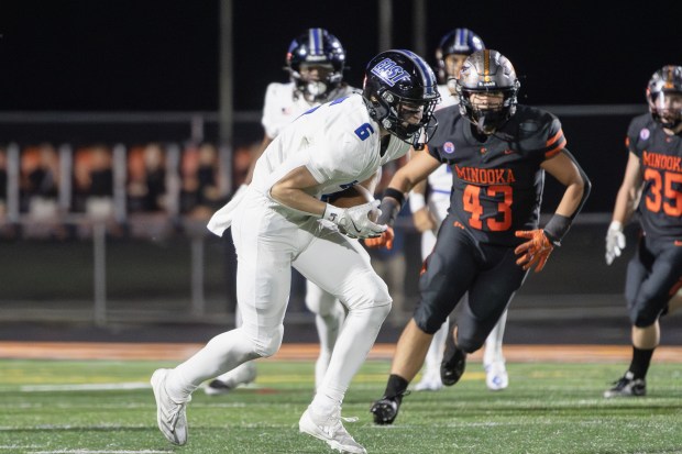 Lincoln-Way East's Keagan Ruane (6) makes a catch against Minooka during a Class 8A second-round game in Minooka on Friday, Nov. 8, 2024. (Troy Stolt / for the Daily Southtown)