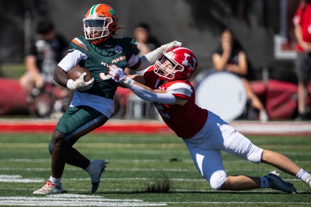 Marist's Brendan Curran, right, tries to hang onto Morgan Park's Terrance Gurley (5) during a nonconference game in Chicago on Saturday, Aug. 31, 2024. (Vincent D. Johnson / Daily Southtown)