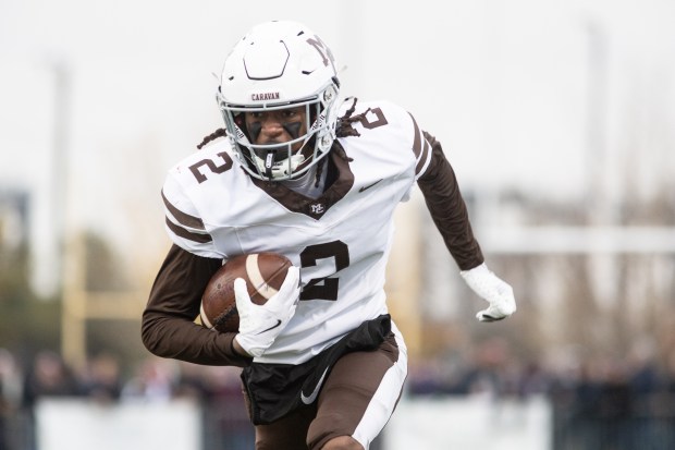 Mount Carmel's Tavares Harrington (2) returns an interception for a touchdown against St. Rita during a Class 7A state semifinal game in Chicago on Saturday, Nov. 23, 2024. (Troy Stolt / for the Daily Southtown)