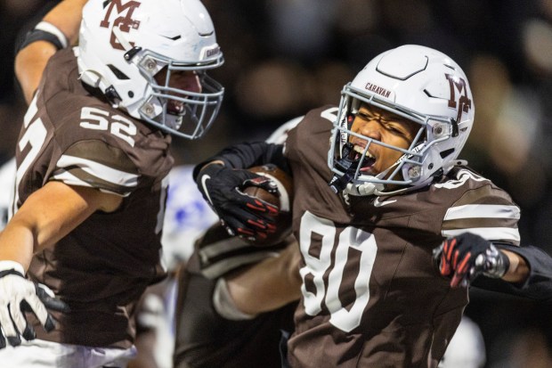 Mount Carmel's Marshaun Thornton (80) and Nicholas Lewanski (52) celebrate Thornton's touchdown reception against St. Charles North during the Class 7A second-round game in Chicago on Saturday, Nov. 9, 2024. (Vincent D. Johnson / for the Daily Southtown)