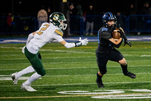 Lincoln-Way East's Brody Gish (20) runs with the ball during the Class 8A state quarterfinal game against Stevenson on Friday, Nov. 15, 2024, at Lincoln-Way East High School in Frankfort, Ill. (Vincent Alban / Daily Southtown)