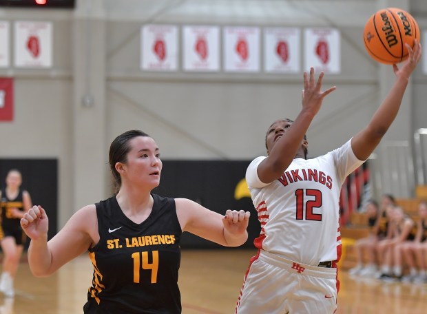 Homewood-Flossmoor's Jemiyah McDonald hooks the ball over St. Laurence's Reaghan Galvin (14) during a Benet/Naperville North Tournament game on Friday, Nov. 22, 2024 in Lisle...(Jon Cunningham for the Daily Southtown)