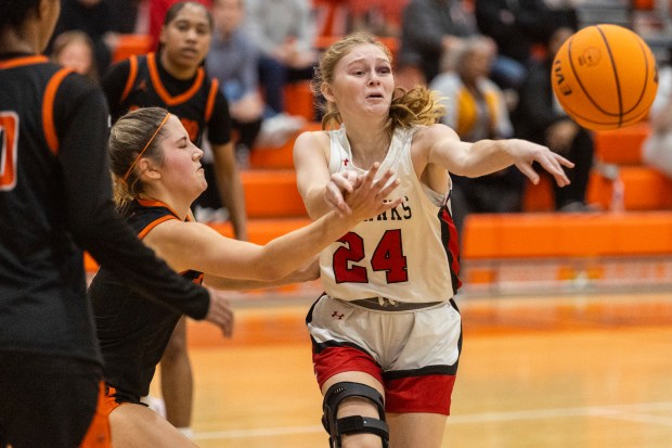 Marist's Chloe Mlyniec (24) passes in the lane against Shepard during the Bobby Bolton Classic in Palos Heights on Tuesday, Nov. 19, 2024. (Vincent D. Johnson / for the Daily Southtown)