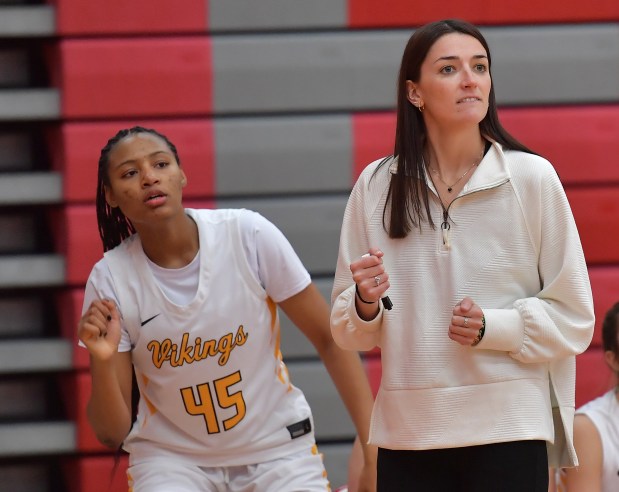 St. Laurence's Marlee-Michelle Coleman (45) reacts to teammates' play on the floor with head coach Claire Austin late in a game against De La Salle on Tuesday, Nov. 26, 2024 in Naperville...(Jon Cunningham for the Daily Southtown)