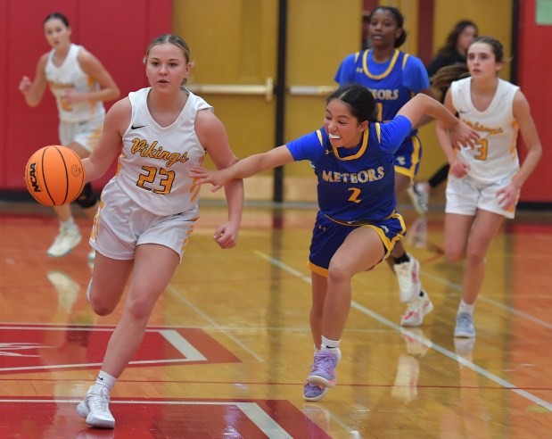 St. Laurence's Nina Villa (23) drives the court as De La Salle's Ellie Cabrera (2) defends during a game on Tuesday, Nov. 26, 2024 in Naperville...(Jon Cunningham for the Daily Southtown)