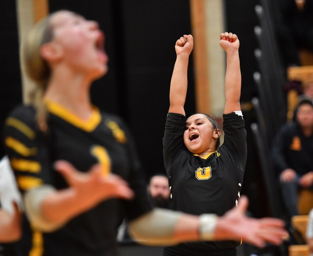 St. Laurence's Vianne Villa (right) celebrates a point with teammate Aubrey Martinez during the Class 3A Hinsdale South Supersectional match on Monday, Nov. 11, 2024 in Darien...(Jon Cunningham for the Daily Southtown)