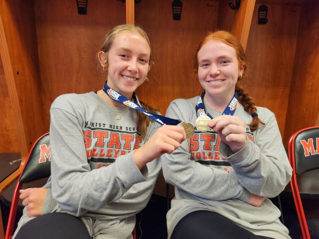 Marist seniors Bella Bullington, left, and Maddie Berry wear their Class 4A state championship medals at the school in Chicago on Tuesday, Nov,. 19, 2024. (Tony Baranek / Daily Southtown)