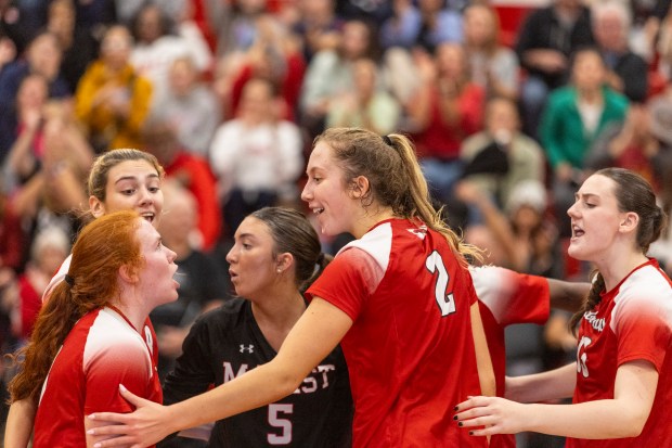 Marist's Maddie Berry, left, and Bella Bullington (2), celebrate after a Red Hawks' point late in the second game against Lincoln-Way East during the Class 4A Marist Sectional semifinals in Chicago on Tuesday, Nov. 5, 2024. (Vincent D. Johnson / for the Daily Southtown)