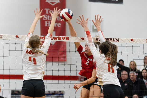 Marist's Bella Bullington (2) spikes the ball against Mother McAuley during the Class 4A Marist Sectional final match in Chicago on Thursday, Nov. 7, 2024. (Troy Stolt / for the Daily Southtown)