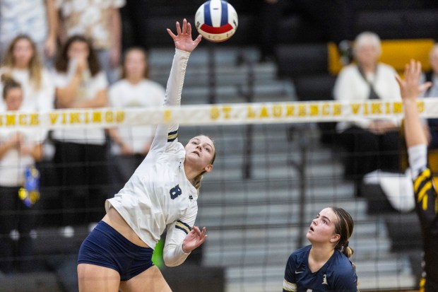 Lemont's Sophia Swiderski (8) powers the ball over the net to St. Laurence during the Class 3A St. Laurence Sectional championship match in Burbank on Thursday, Nov. 7, 2024. (Vincent D. Johnson / for the Daily Southtown)