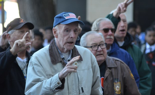 Leo High School veterans and alumni sing the school's fight song Nov. 7, 2024, during a ceremony at the John P. Fardy Courtyard in Chicago. (Jeff Vorva / for the Daily Southtown)