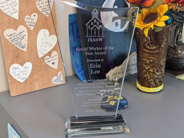 A plaque awarded to Oak Lawn Comunity High School social worker Erin Lee rests in her office among items and messages given to her by students. (Janice Neumann/Daily Southtown)