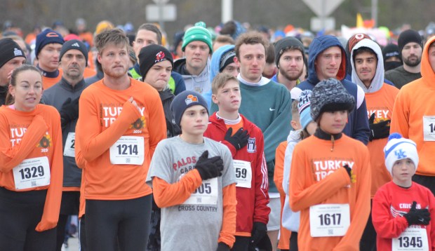 Runners, including Turkey Trot winner Andrew Bowman, No. 1214, listen to "The Star-Spangled Banner" before the race Nov. 28, 2024. (Jeff Vorva/for the Daily Southtown)