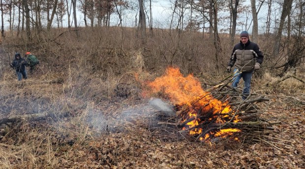 Burning brush is an effective way to eliminate plant waste, but only volunteers who are certified as brush pile burn bosses are allowed to head up the task. (Phyllis Schulte)