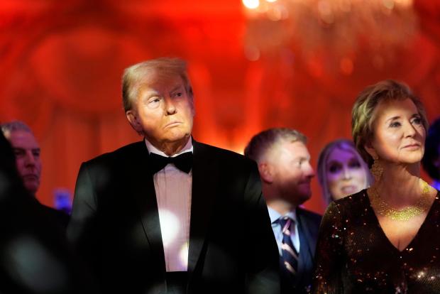 President-elect Donald Trump listens with Linda McMahon during an America First Policy Institute gala at his Mar-a-Lago estate, Thursday, Nov. 14, 2024, in Palm Beach, Fla. (AP Photo/Alex Brandon)